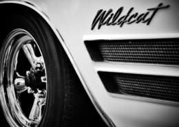 SCP_3 Chrome and White Buick Wildcat car picture of back pasenger side wheel and Wildcat name with 2 horizontal inset vents below it